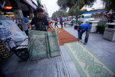 People lay out floor mats on which people will break the fast. JP/ Boy T. Harjanto