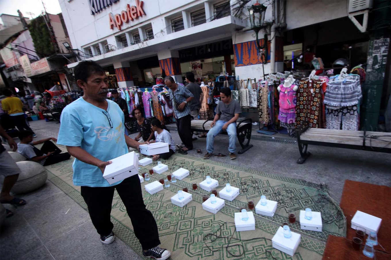 Kotak makan berisi nasi dan lauk pauk digelar di atas karpet | Foto: Boy T. Harjanto / Jakarta Post