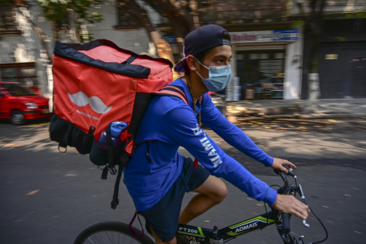 A boy working as a food delivery wears a face mask in Mexico City, on May 16, 2019. 