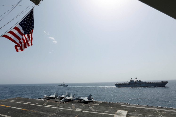 The U.S. Navy Wasp-class amphibious assault ship USS Kearsarge and the Arleigh Burke-class guided-missile destroyer USS Bainbridge sail alongside the Nimitz-class aircraft carrier USS Abraham Lincoln in the Arabian Sea May 17, 2019. Picture taken May 17, 2019. 