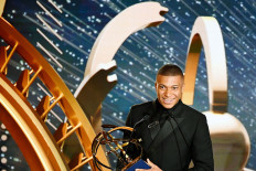 Free world: Paris Saint-Germain’s French forward Kylian Mbappe receives the Best Ligue 1 player award on May 19 in Paris, during the 28th edition of the French National Professional Football Players Union trophy ceremony.