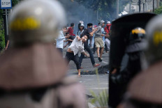 Protestors throw rocks at antiriot police in Petamburan, Central Jakarta. JP/Jerry Adiguna