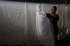 A worker at Ong’s Art Maranatha batik house dries fabric after they are washed before the batik-making process begins. JP/Sigit Pamungkas