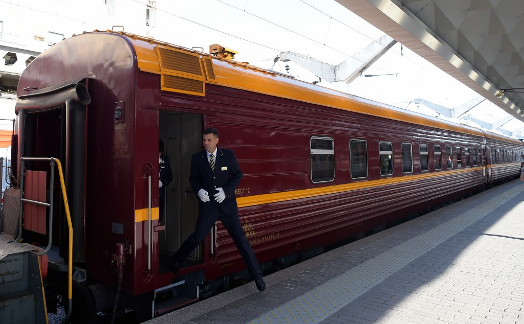 A train conductor steps down from a car of the first tourist train passing through Russia's Arctic regions to Norway as it prepares to leave Saint Petersburg for a 11-day trip with 91 passengers on board, June 5, 2019.