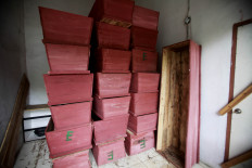 Stacked high: The red coffins at the Petamburan Cemetery office in Central Jakarta are reserved for unidentified bodies found by the Palang Hitam team. JP/Iqbal Yuwansyah