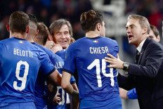 Good start: Italy's coach Roberto Mancini (right) celebrates with forward Federico Chiesa during their UEFA Euro 2020 qualification soccer match against Bosnia Herzegovina at the Allianz Stadium in Turin on Tuesday. 