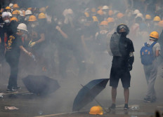 Protesters scuffle with Hong Kong police, govt offices shut down