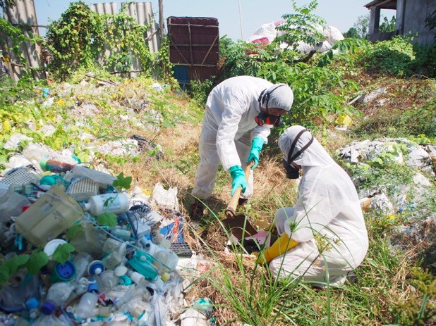 Officials from the Environment and Forestry Ministry examine a pile of suspected hazardous medical waste in Karawang, West Java, in this undated photo.