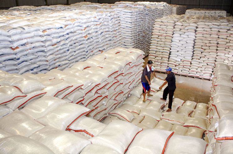Workers carry sacks of medium quality rice on Monday in a warehouse belonging to the State Logistics Agency (Bulog) in Purwasari, Karawang, West Java. The agency has reached 70 percent of the 15.6 million families across the country entitled to noncash food assistance.
