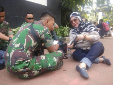 Woman scouts around for son-in-law among troops safeguarding Constitutional Court