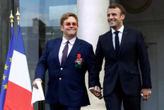 Hand-in-hand, Macron and Elton John join forces on AIDS
