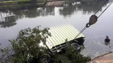 Tree branch causes truck to fall into river in West Jakarta