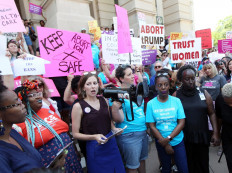 Shot American woman who miscarried faces homicide charge