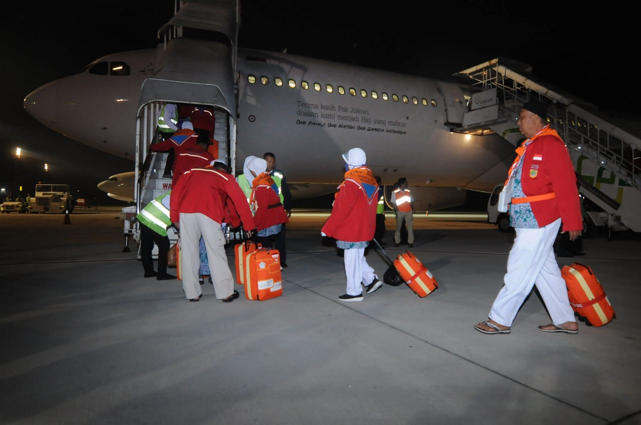Haj pilgrims from Sukoharjo regency board an airplane on July 7, 2019 at Adi Soemarmo airport in Boyolali, Central Java. The government has cancelled its 2020 haj program amid the coronavirus pandemic.