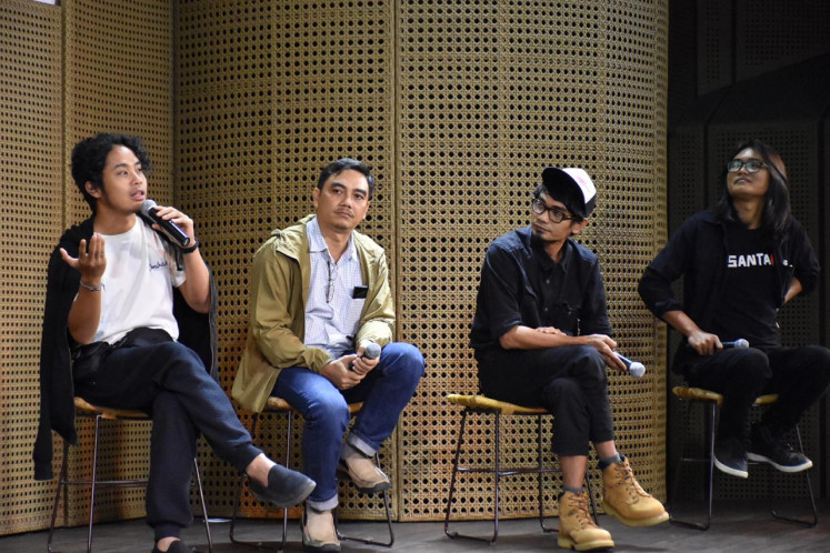 Behind the scenes: WWF researcher Veda Santiadji (second left) and photographers Andi Imam Prakasa (left), Prabhoto Satrio (second right) and Andi Ari Setiadi take part in a discussion as panelists at the Jakarta International  Photo Festival (JIPFest) at Galeri Indonesia Kaya in Jakarta.