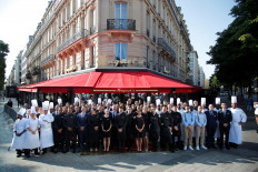Employees of the Fouquet's restaurant pose together on the eve of its reopening on the Champs Elysees, almost 4 months after it was ranksacked by a 'yellow vests' protest in Paris, France, on July 13, 2019. 