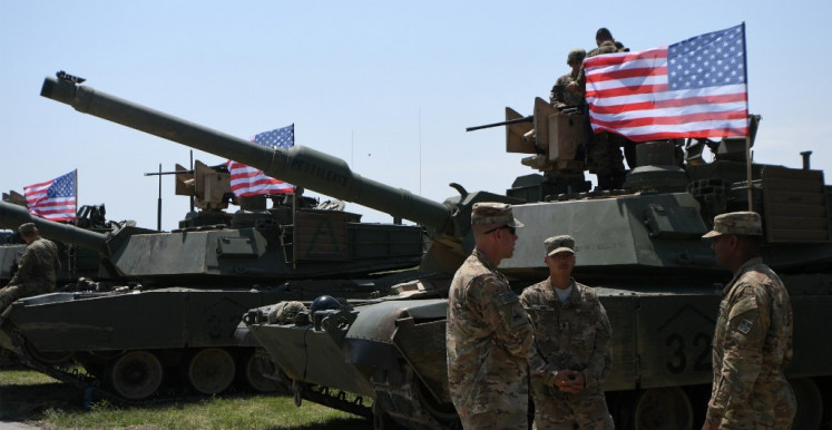 US soldiers stand by Abrams Battle Tanks bearing the US flag prior to the opening ceremony of the joint multinational military exercise 'Noble Partner 2017' at the military base of Vaziani, outside Tbilisi, on July 30, 2017. 