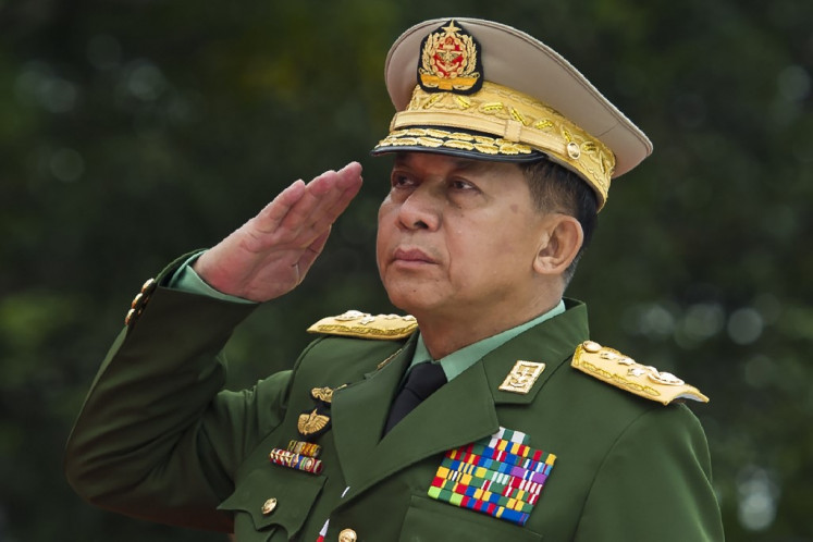 This file photo taken on July 19, 2018, shows Myanmar's Chief Senior General Min Aung Hlaing, commander-in-chief of the Myanmar armed forces, saluting to pay his respects to Myanmar independence hero General Aung San and eight others assassinated in 1947, during a ceremony to mark the 71th anniversary of Martyrs' Day in Yangon. The US said on July 16, 2019, it would ban entry into the country of Myanmar's army chief and four other generals due to their role in 
