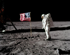 Astronaut Buzz Aldrin, lunar module pilot for Apollo 11, poses for a photograph beside the deployed United States flag during an extravehicular activity (EVA) on the moon, July 20, 1969. 