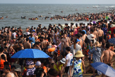 This picture taken on July 20, 2019 shows people relaxing on Sam Son beach in Thanh Hoa province. 