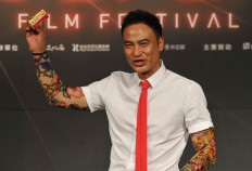 Hong Kong actor and film producer Simon Yam poses for photos during a press conference to promote Chan's latest film 'The Midnight After' in Taipei on July 13, 2014.