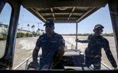 An Iraqi policeman pilots a speedboat while on patrol to prevent people attempting suicide from jumping in the Tigris river in the center of the capital Baghdad on May 10, 2019. 
