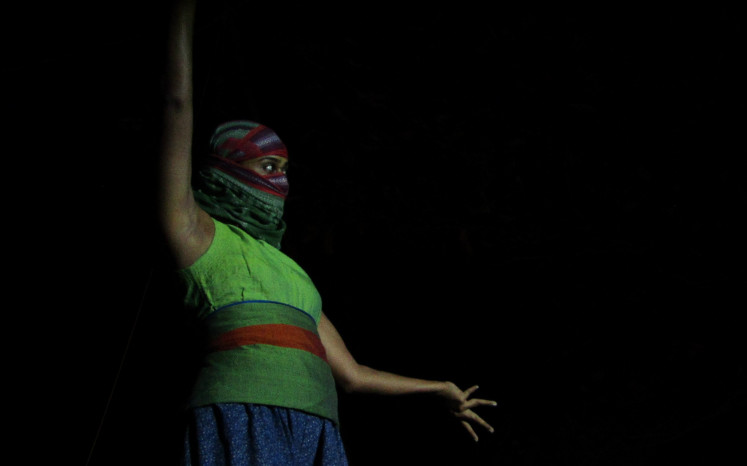 Darkness surrounds her: Sri Lankan performer Venuri Perera appears on stage to express her anxieties as a citizen of conflict- prone Sri Lanka. 