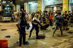 Clashes in Hong Kong after police charge protesters with rioting