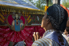 Come to me: An image of Jesus Christ is seen on a traditional Javanese tent. JP/ Tarko Sudiarno
