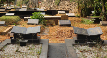 Crammed Jakarta pushes the dead to share space