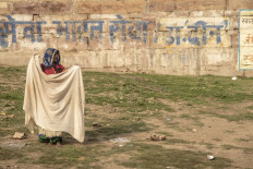 A woman dries clothes in the sun. JP/Tyler Blodgett