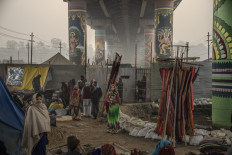 People gather beneath a painted cement bridge within the Mela. JP/Tyler Blodgett