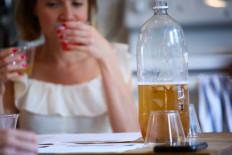 A woman drinks Kombucha as she attends a workshop by Fermentationist Cheryl Paswater in the Brooklyn borough of New York City, on June 29, 2019. 