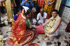 This photo taken on August 5, 2019 shows transgender woman Tista Das (L) 38, and transgender man Dipan Chakraborty, 40, performing the rituals of a traditional Hindu marriage ceremony in Kolkata. The transgender couple, who have both undergone sex reassignment ceremony, tied their knot in Kolkata during a traditional function attended by friends and family.
