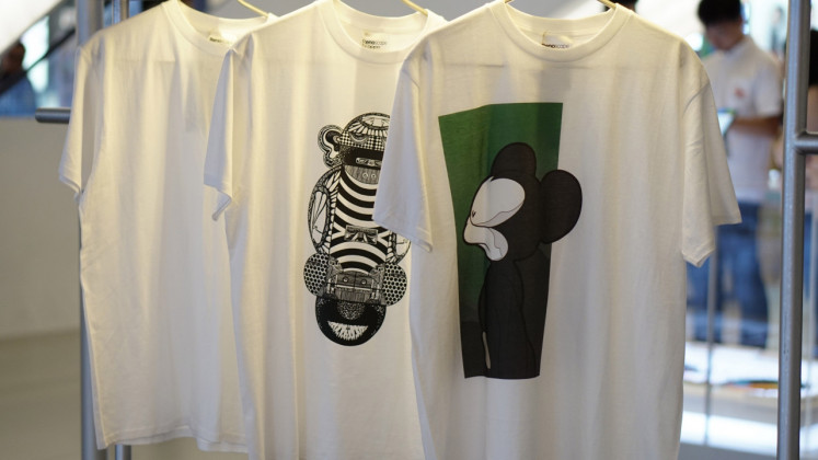 T-shirts are displayed for sale during Oppo's Renoscape exhibition. Proceeds from sales will be donated to Rachel House, a nonprofit organization that provides palliative care for children. 