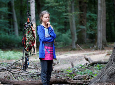 Greta Thunberg, Swedish 'Fridays for Future' climate activist, stands next to climbing equipment that hangs from an illegal tree house in the Hambach Forest that is supposed to be chopped away for the nearby open-cast brown coal mine of German utility RWE, west of Cologne, Germany, on August 10, 2019. 