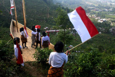 Students of SMP 1 state junior high school in Ngargoyoso carry flags in Sumilir Valley. JP/Maksum Nur Fauzan