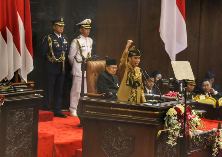 Standing at the podium in House of Representatives complex, Jokowi donned a golden-colored attire with black-god sarong and traditional headband, which originates from West Nusa Tenggara.