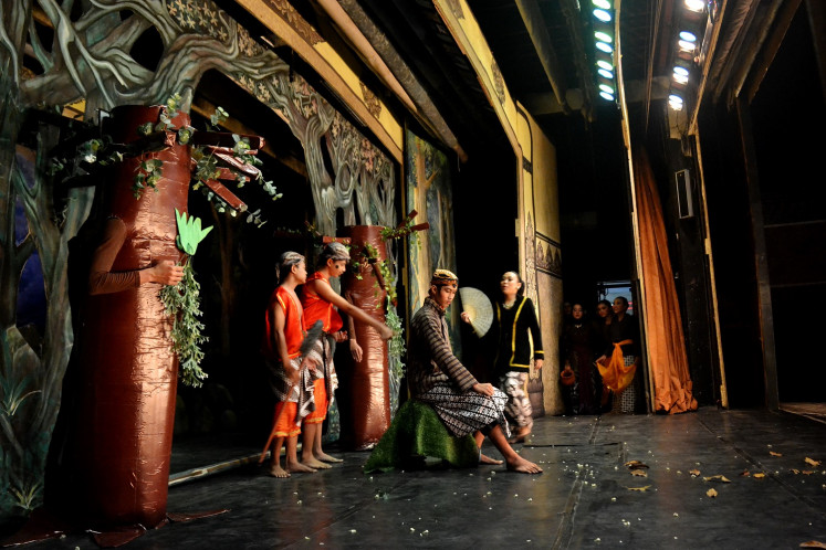 Students of SMP 4 state junior high school of Surakarta act in a human puppet performance at the Sriwedari building.