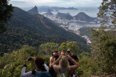 People take photos as they walk along a hiking trail -part of a projected 8,000-kilometer trail across Brazil, which will be one of the losgest in the Americas- in Rio de Janeiro, Brazil, on July 21, 2019. 