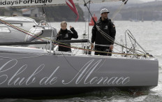 Swedish climate activist Greta Thunberg (L) and German captain Boris Herrmann wave from aboard the Malizia II IMOCA class sailing yacht, off the coast of Plymouth, southwest England, on August 14, 2019, as she prepares to start her journey across the Atlantic to New York where she will attend the UN Climate Action Summit next month.