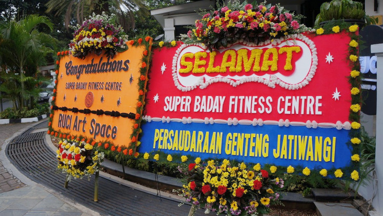 Flower boards at the entrance of Ruci Art Space display congratulatory messages on the establishment of the Super Baday Fitness Center