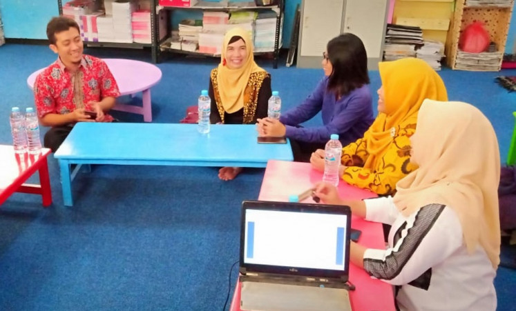 Several regional language teachers of junior high schools in Surabaya, East Java, discuss learning materials before recording their lessons. 