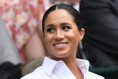 Britain's Meghan, Duchess of Sussex, sits in the Royal Box on Centre Court to watch Romania's Simona Halep playing US player Serena Williams during their women's singles final on day twelve of the 2019 Wimbledon Championships at The All England Lawn Tennis Club in Wimbledon, southwest London, on July 13, 2019. 