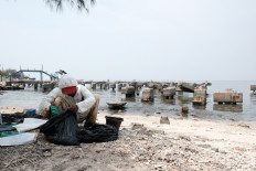 On the northern tip of Jakarta, fishermen catch oil, not fish, after Pertamina well accident