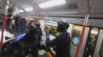 Hong Kong police baton-charge train compartment