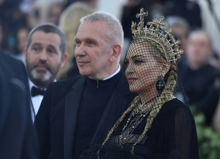 Posh: French Designer Jean-Paul Gaultier (left) and Madonna arrive for the 2018 Met Gala on May 7, 2018, at the Metropolitan Museum of Art in New York. The tiara worn by Madonna is the creation of Indonesian accessories designer Rinaldy A. Yunardi.