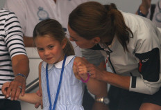 Britain's Catherine, Duchess of Cambridge, looks at Britain's Princess Charlotte after she sticked her tongue out before a presentation ceremony following the King's Cup Regatta in Isle of Wight, Britain, on August 8, 2019. 