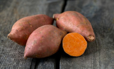 Sweet potatoes on a wooden surface.