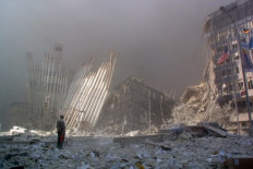  In this file photo taken on September 11, 2001, a man stands in the rubble, and calling out asking if anyone needs help, after the collapse of the first World Trade Center Tower in New York City. The US is observing the 18th anniversary of the 9/11 attacks.
